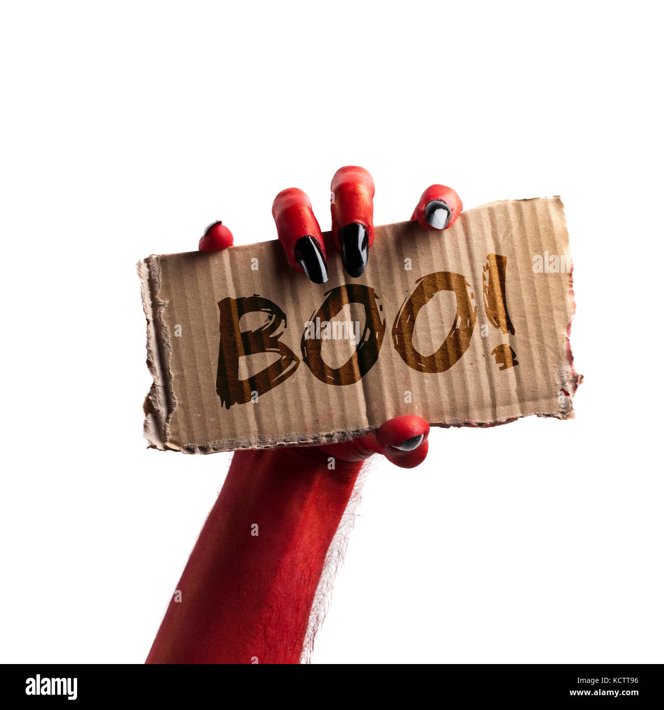 Boo ! Diable rouge ou zombie halloween monster hand holding a sign Banque D'Images