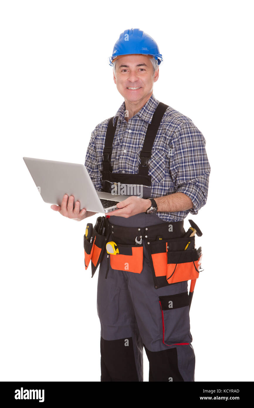 Cheerful technician holding laptop over white background Banque D'Images