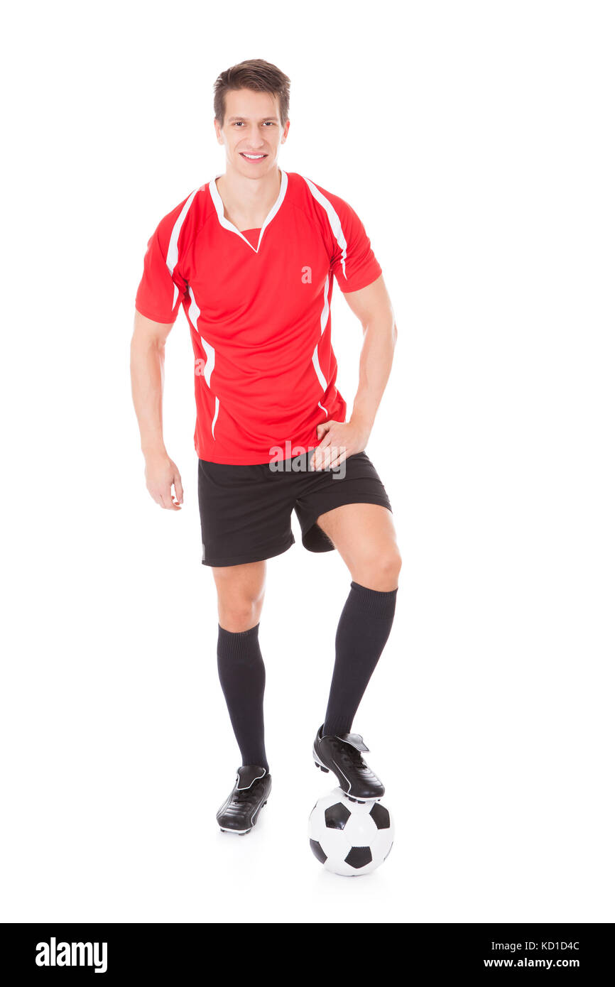 Portrait of young male soccer player holding football Banque D'Images