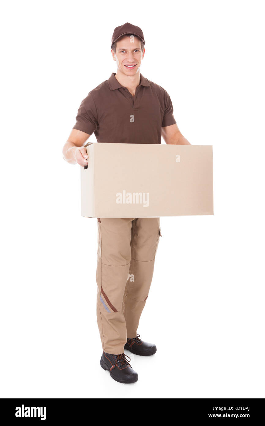 Handsome Man Carrying Cardboard Box Over White Background Banque D'Images