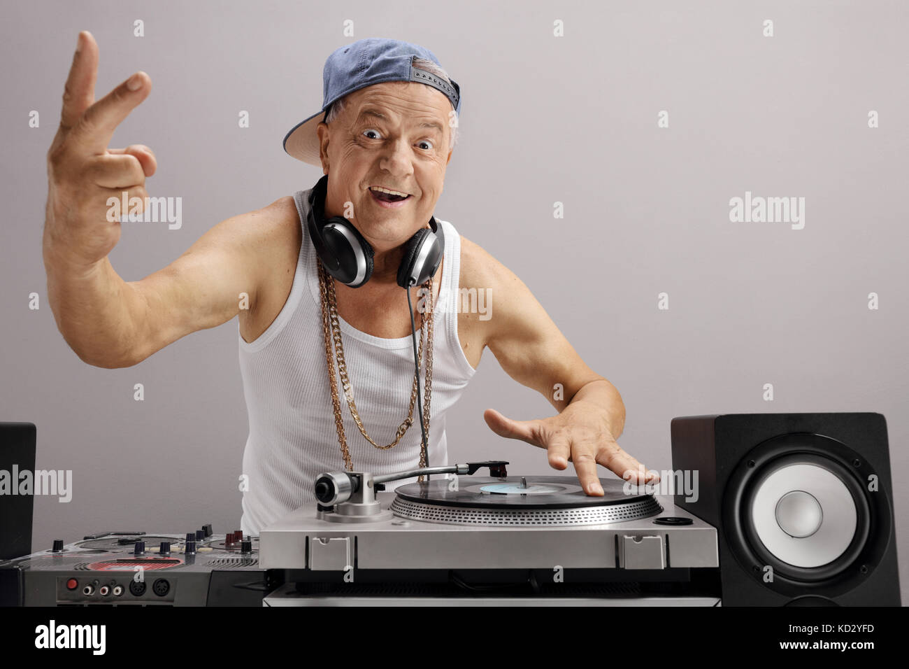 Personnes âgées dj faisant un signe de paix contre un mur gris Banque D'Images