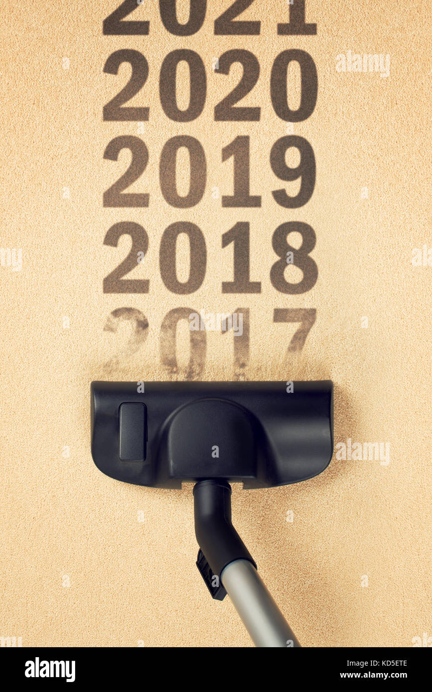 Aspirateur balayant année nombre 2017 à partir de la surface du tapis pour bonne année 2018 concept Banque D'Images