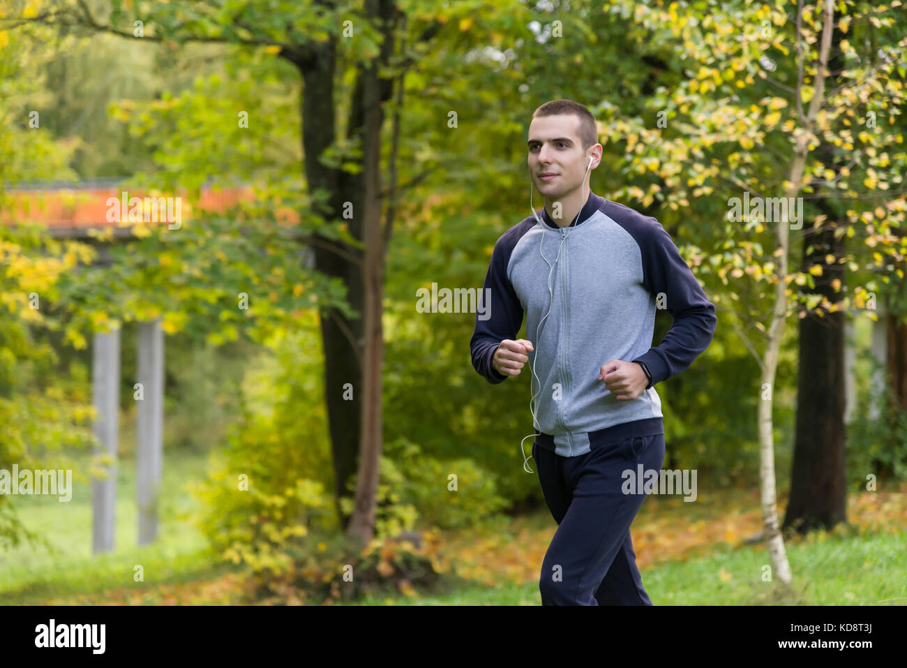 Un homme en vêtements de sport courir dans le parc Banque D'Images