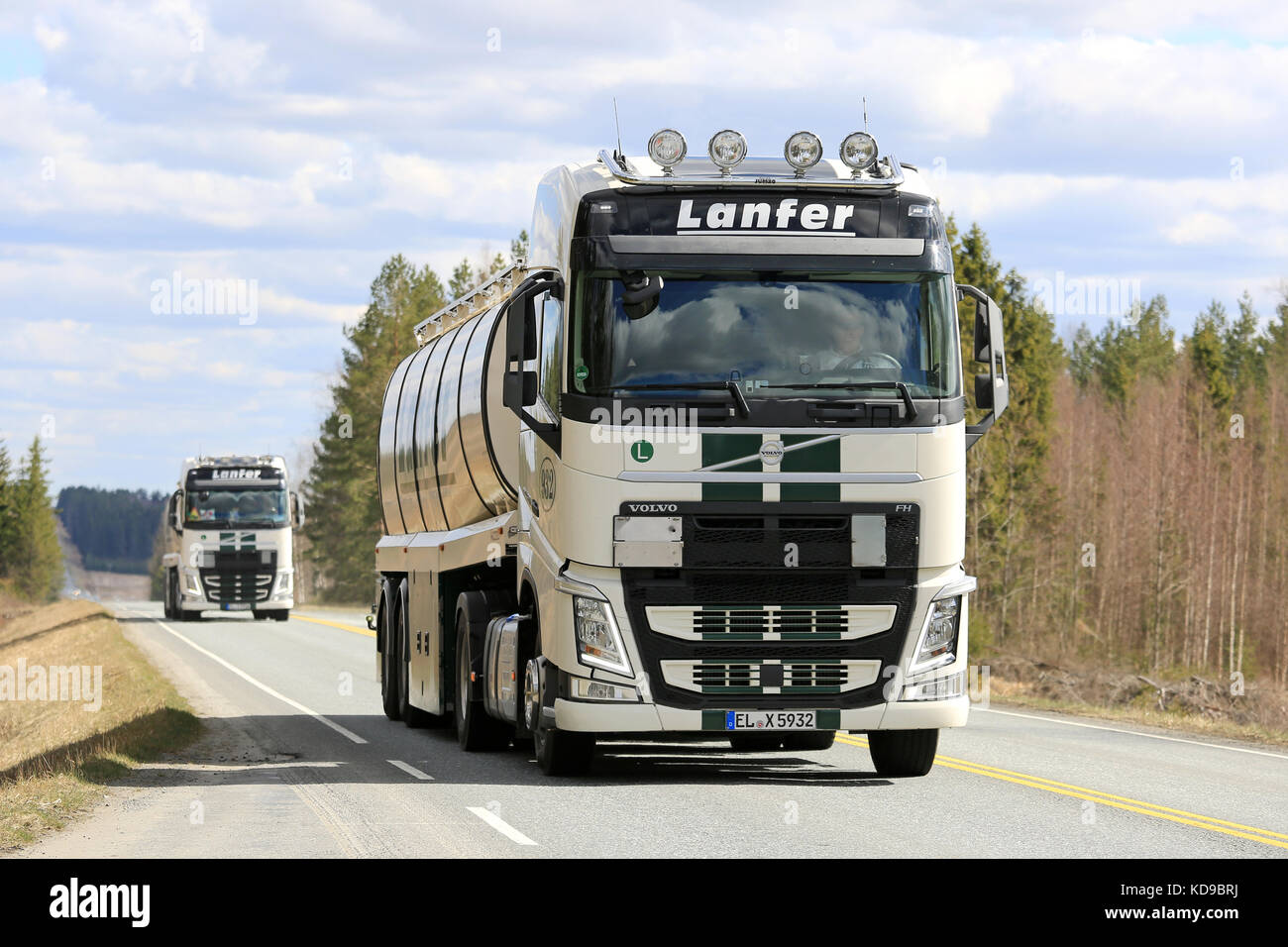 Jokioinen, Finlande - le 7 mai 2017 : deux camions-citernes semi volvo fh de lanfer logistik déplacer le long de la route en convoi sur une belle journée. Banque D'Images