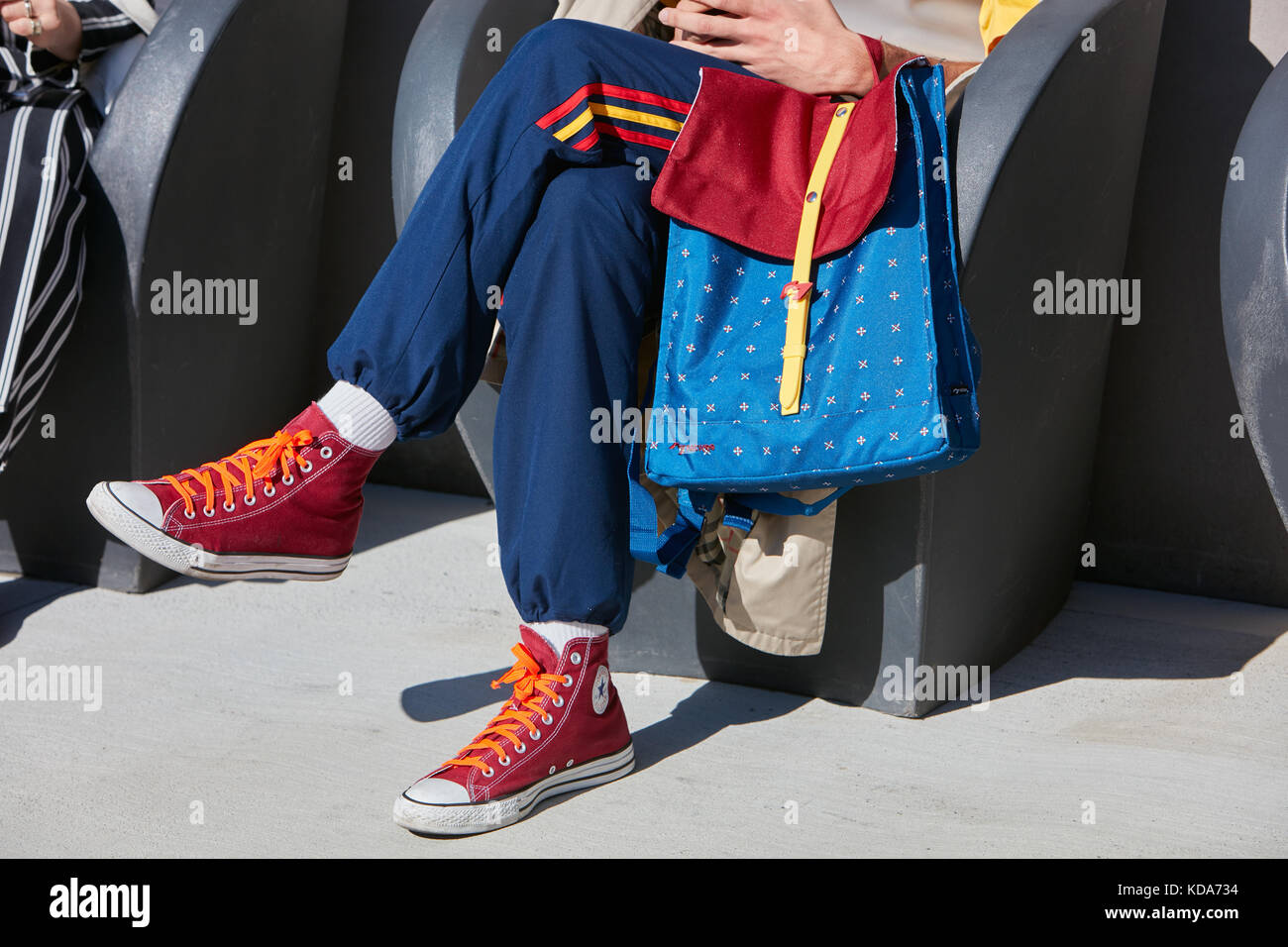 MILAN - 20 SEPTEMBRE : homme avec un sac à dos Natwee rouge et bleu et des chaussures Converse rouges avant le défilé Alberto Zambelli, rue de la semaine de la mode de Milan Banque D'Images