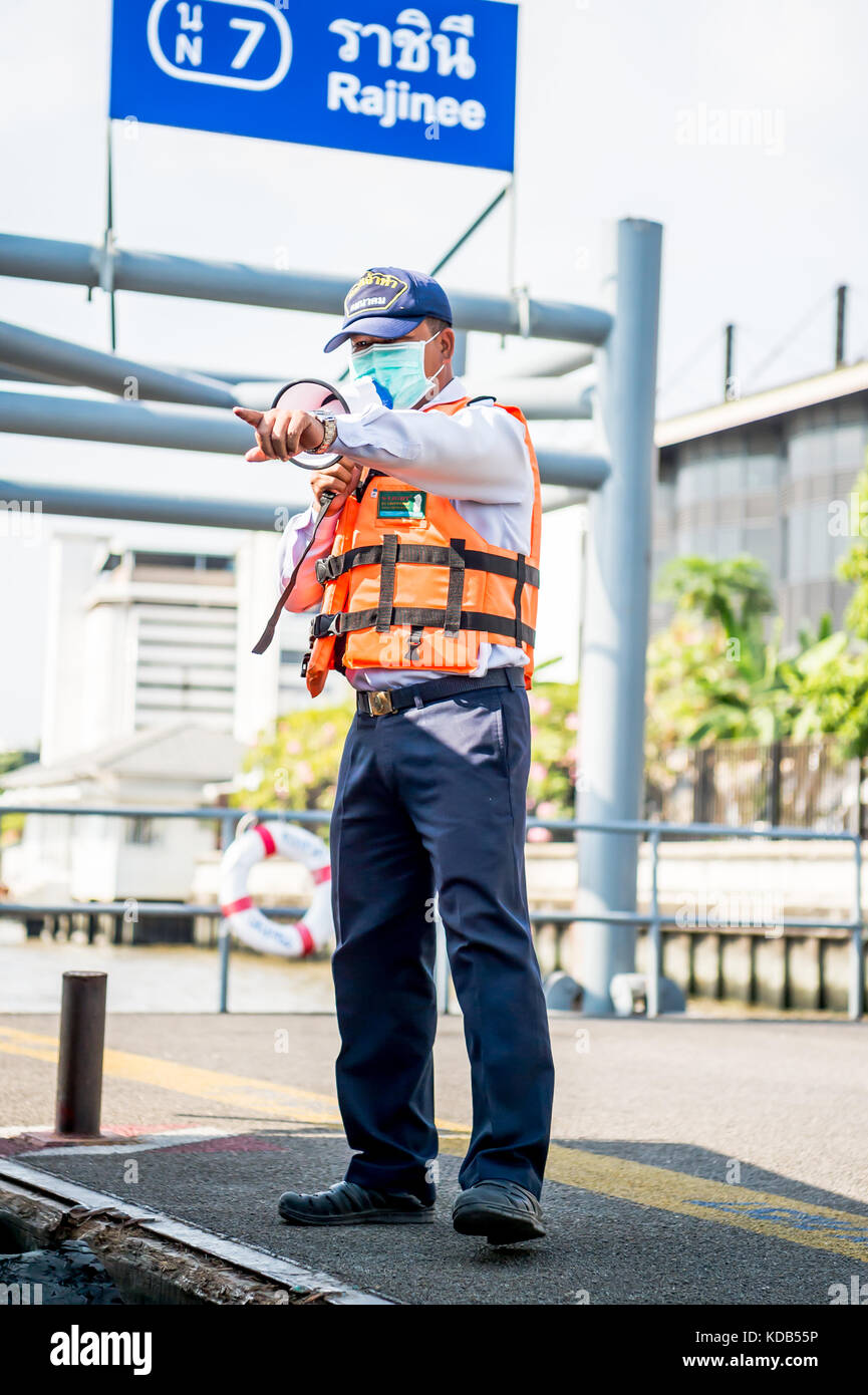 Un port guides officiels les touristes et navetteurs locale thaïlandaise sur et hors le ferry qui traverse la rivière Chao Phraya à Bangkok en Thaïlande. Banque D'Images