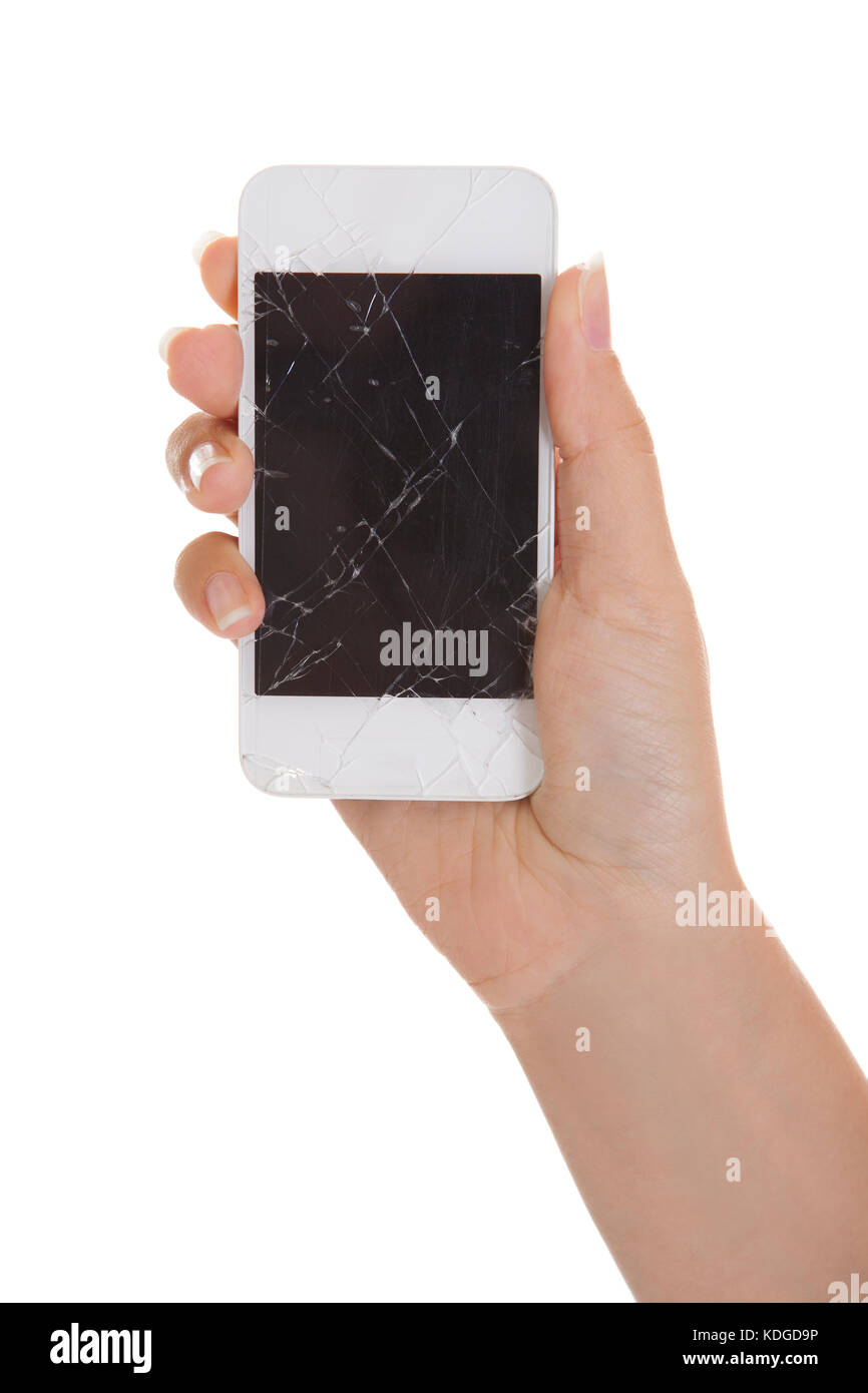 Hand holding Smartphone avec écran fissuré sur fond blanc Banque D'Images