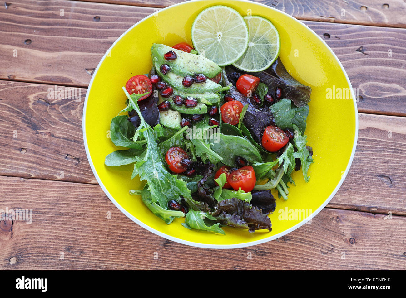 Salade saine avec bébé la laitue et tomates sur la table en bois Banque D'Images