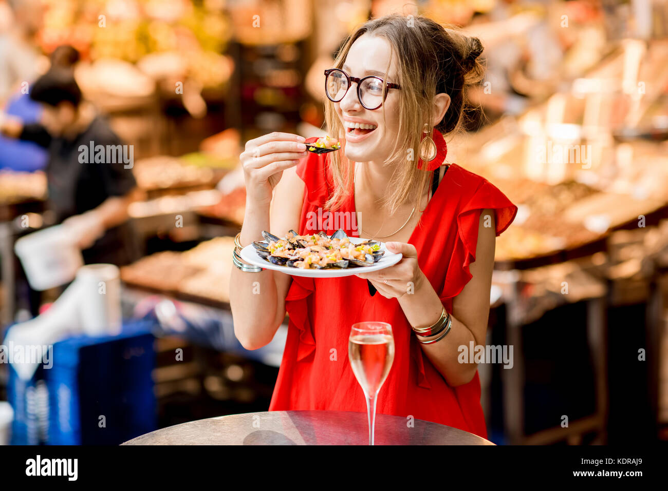 Femme mangé des moules au marché alimentaire Banque D'Images