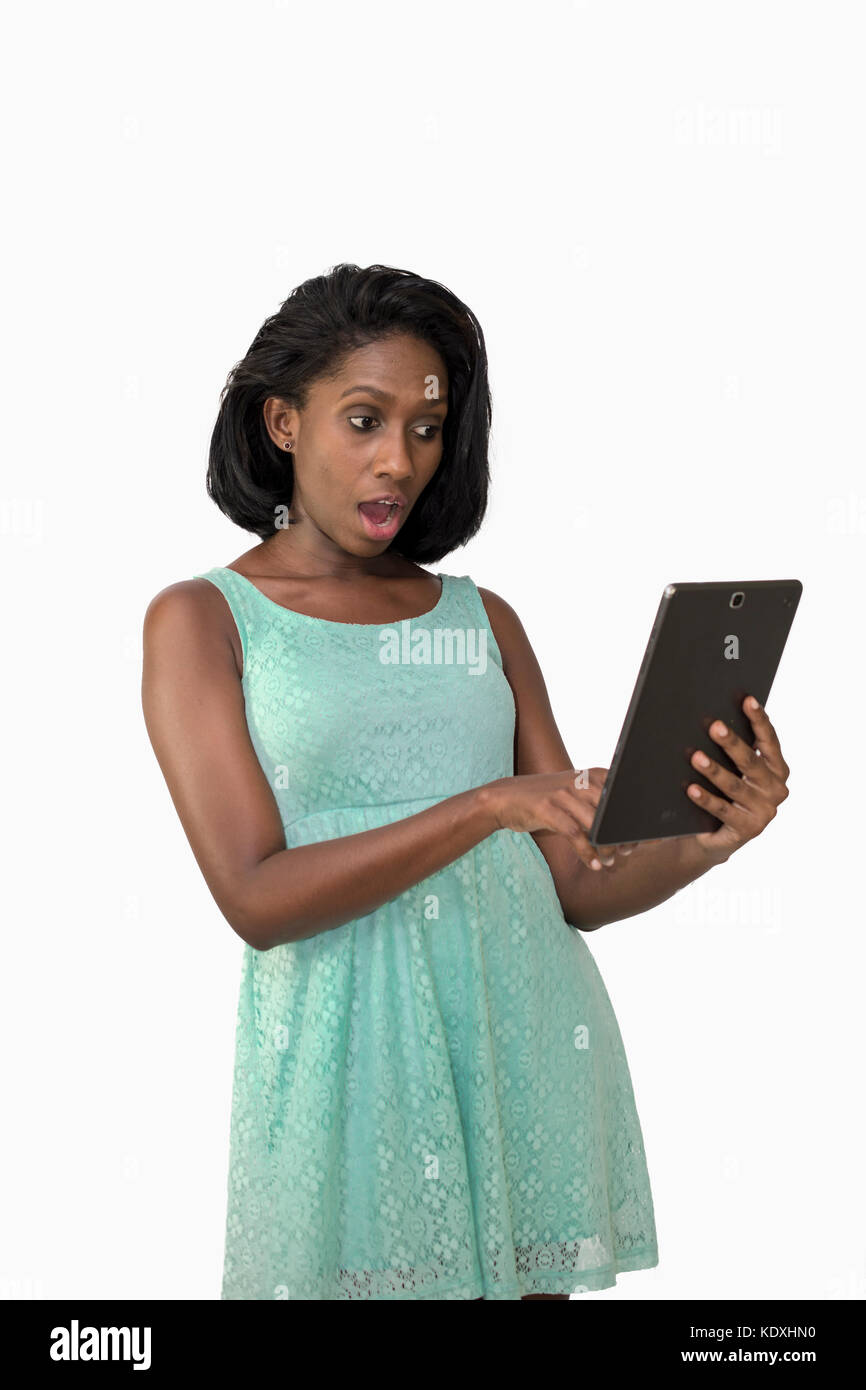 Choqué woman using digital tablet Banque D'Images