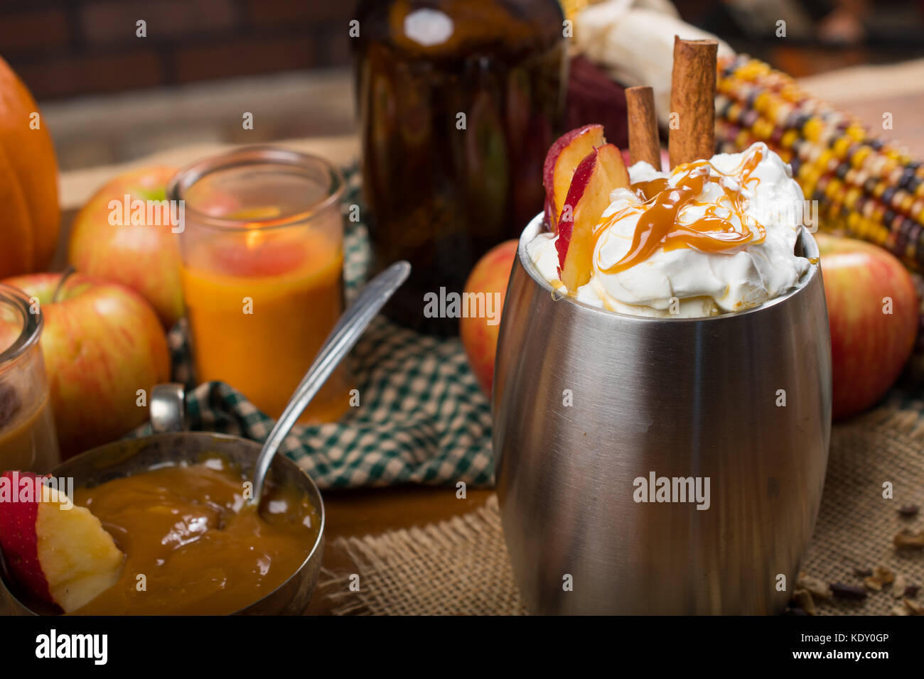Cidre de pomme chaud automne citrouille avec décorations et trempette au caramel avec des bougies. Banque D'Images