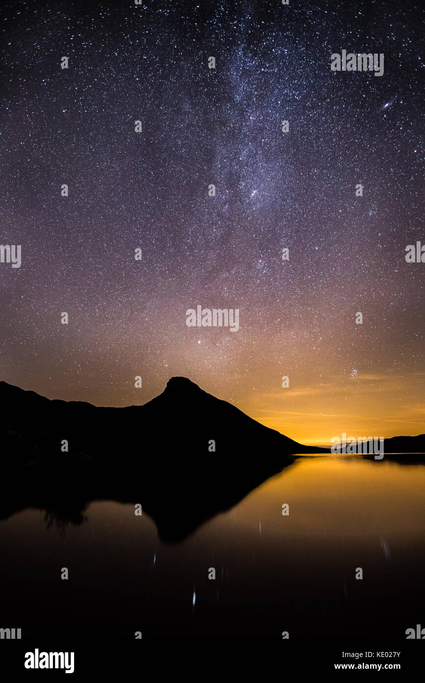Voie Lactée photo de nuit avec la galaxie d'Andromède dans la distance et la pollution lumineuse de la ville voisine Dolgellau, Cregennan Lacs, Pays de Galles, Royaume-Uni Banque D'Images