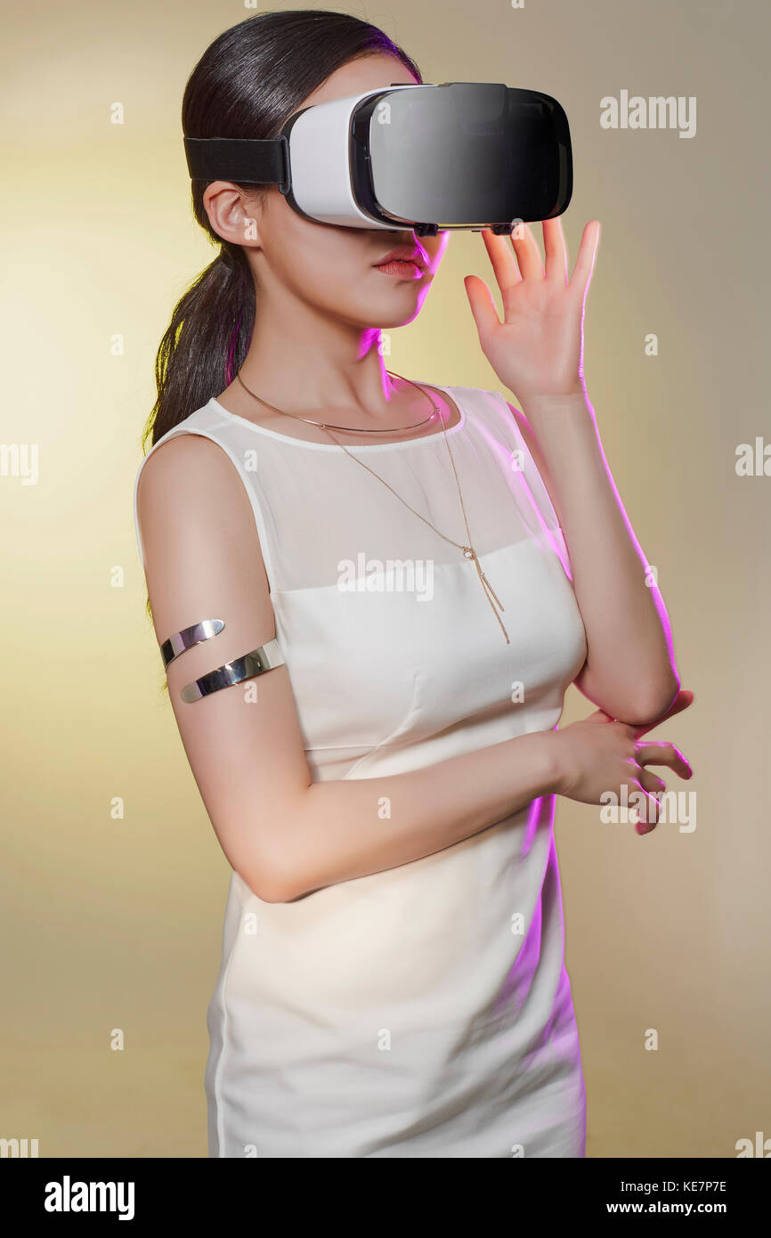 Jeune femme avec casque de réalité virtuelle posing Banque D'Images