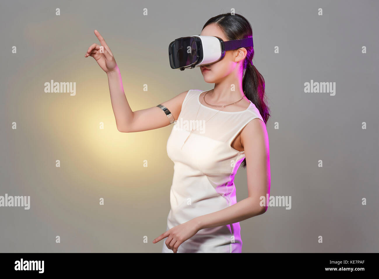Vue latérale du jeune femme avec casque de réalité virtuelle posing Banque D'Images