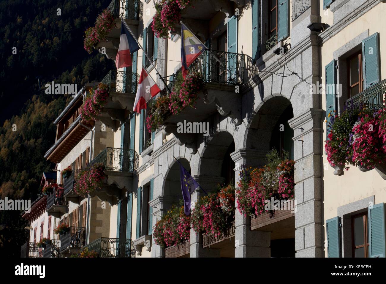 Détail de l'hôtel façade avec fenêtres à fleurs et drapeaux français et suisse, chamonix-mont-blanc, france Banque D'Images
