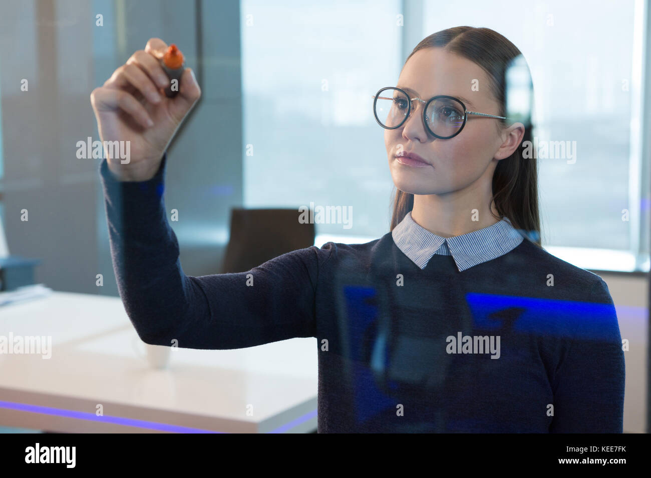 Female executive écrit sur verre in office Banque D'Images