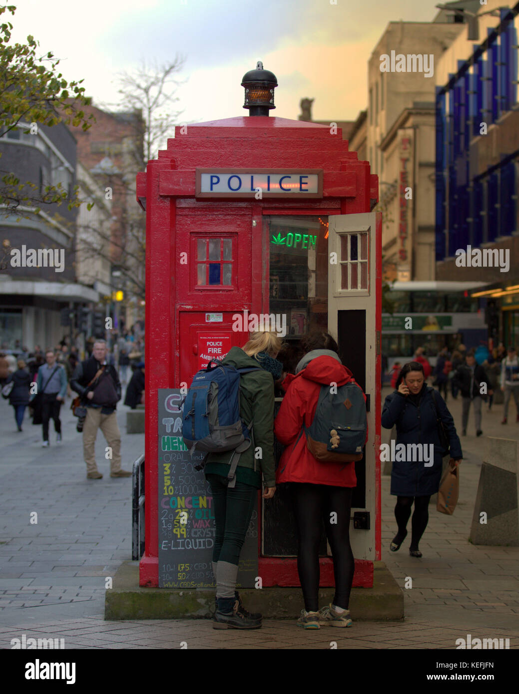 Touristes achètent euphorisants légaux du médecin qui en sortie de décrochage tardis style Sauchiehall Street Glasgow vu de derrière Banque D'Images