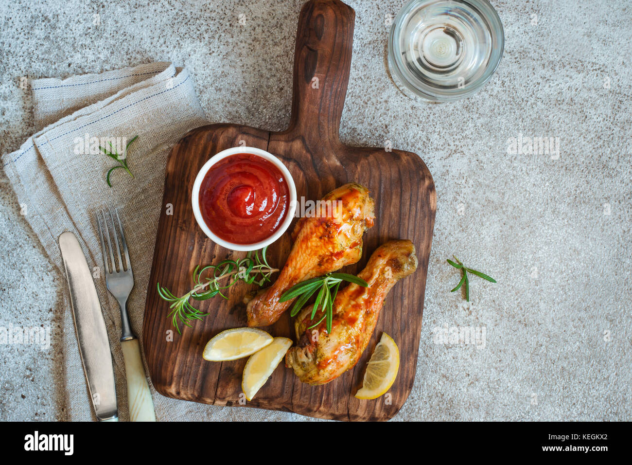 Pilons de poulet épicé grillé est servi sur une planche de bois. Top View with copy space Banque D'Images