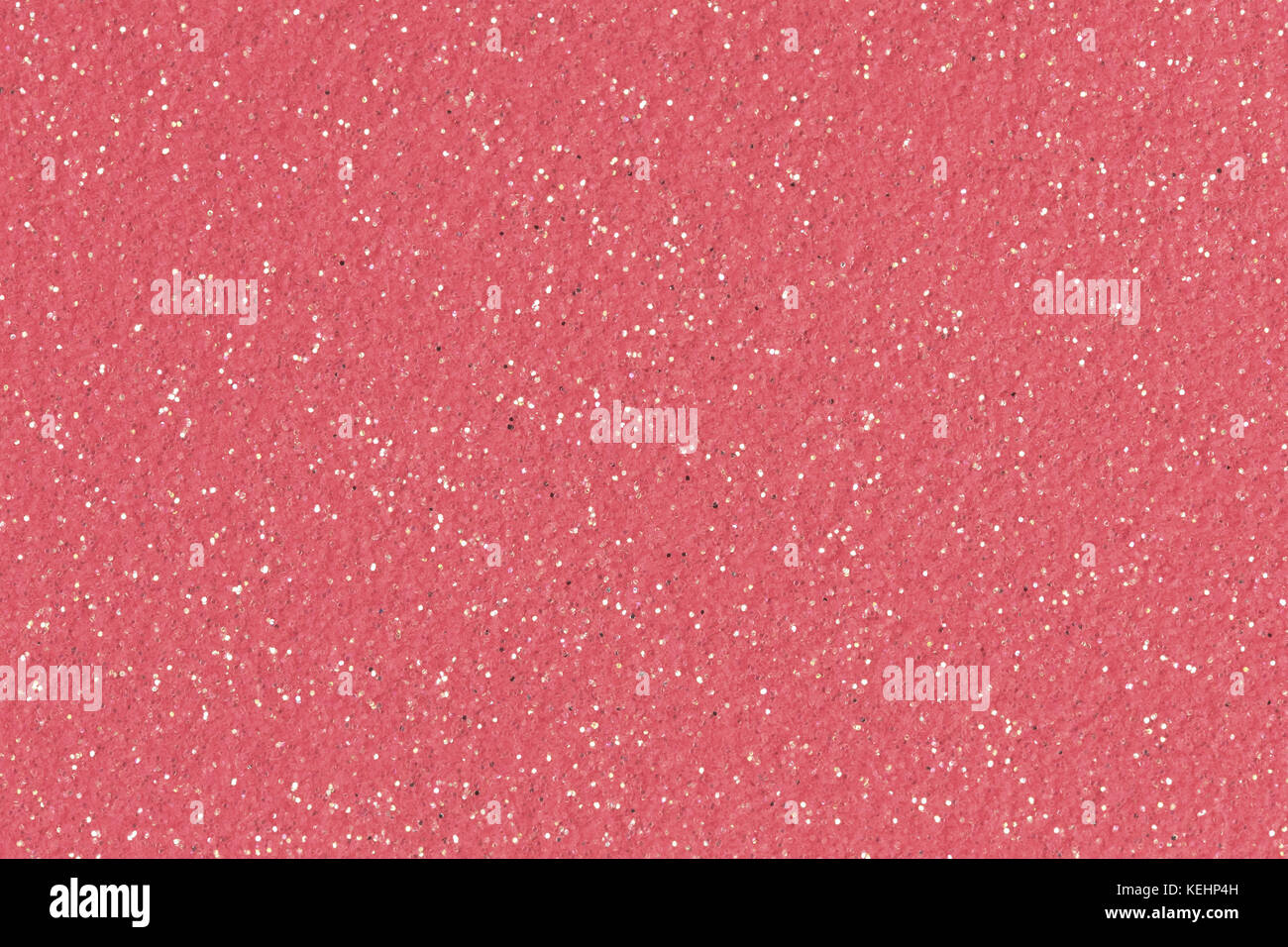 Fond rose de Noël avec des paillettes. Photo de contraste faible. Banque D'Images