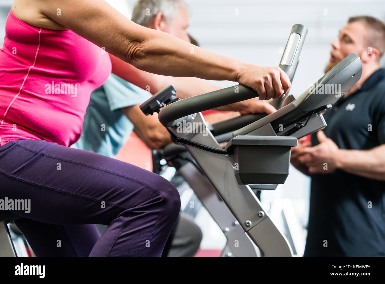 Les aînés de tourner avec un entraîneur personnel dans la salle de sport Banque D'Images