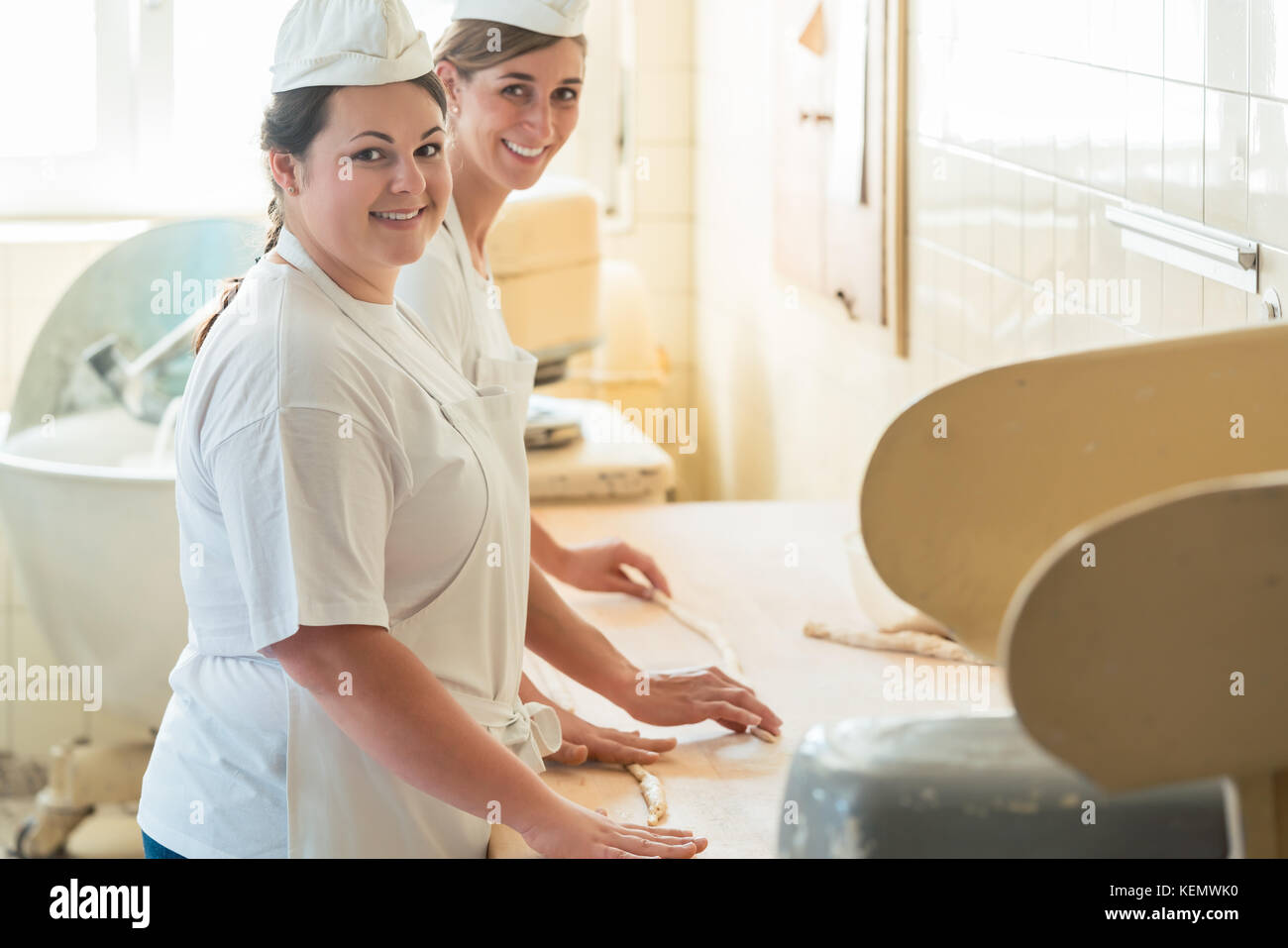 Baker femmes travaillant dans le fournil d'une boulangerie Banque D'Images