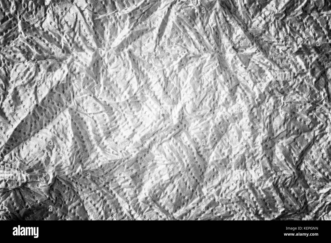 Surface texturée blanche froissée avec arrière-plan de points à motifs Banque D'Images