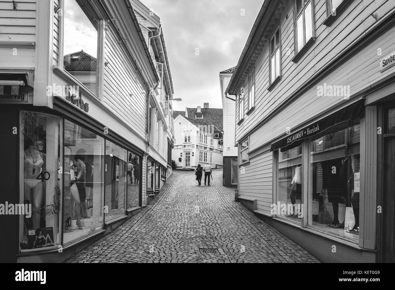 La Norvège, Stavanger, 07.30.2013 . Triste solitude couple de personnes âgées est sur une rue déserte . Le noir et blanc. La structure horizontale. Editorial Banque D'Images
