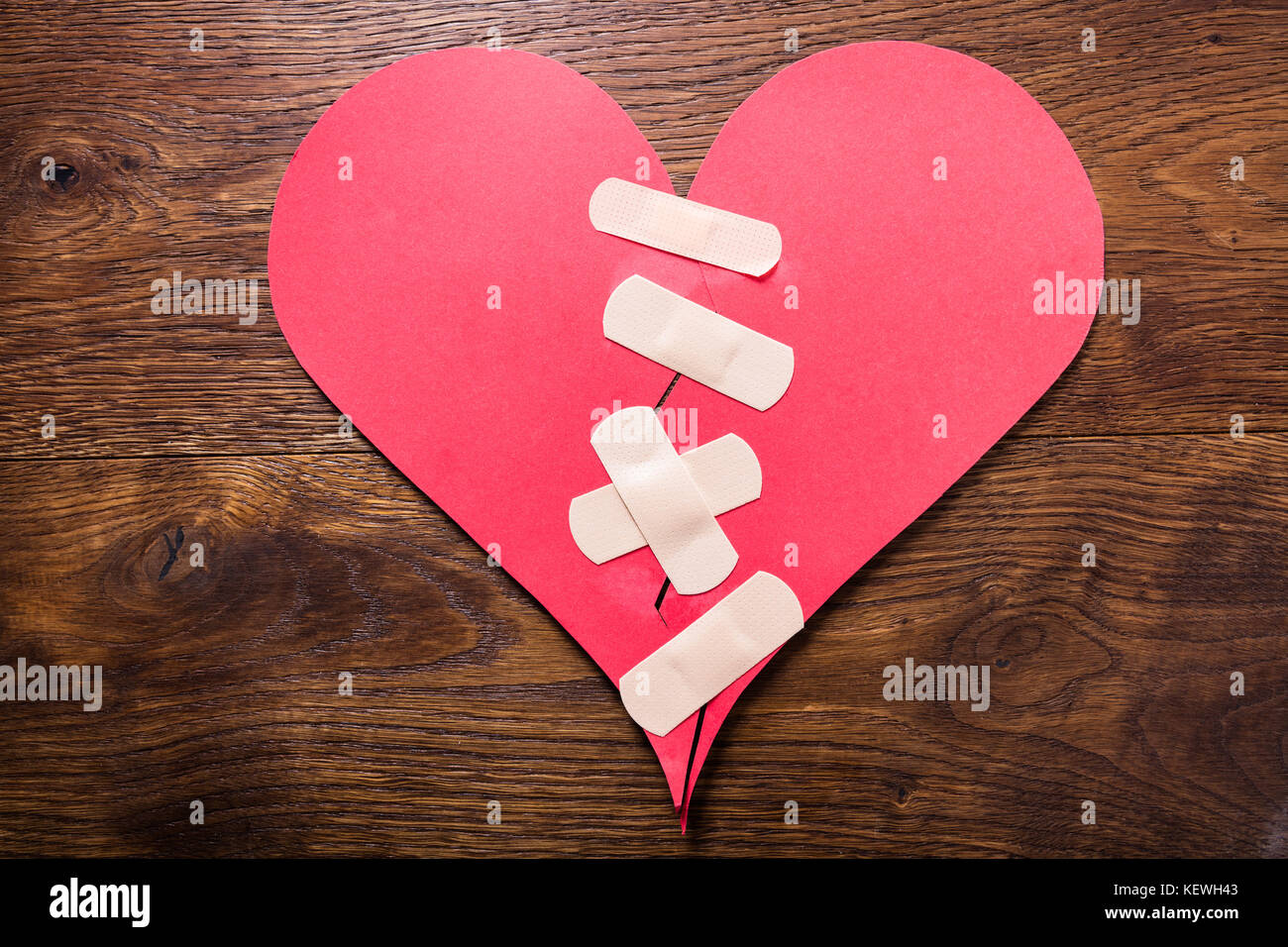 High Angle View Of A Broken Heart fixe avec bandage sur un bureau en bois Banque D'Images