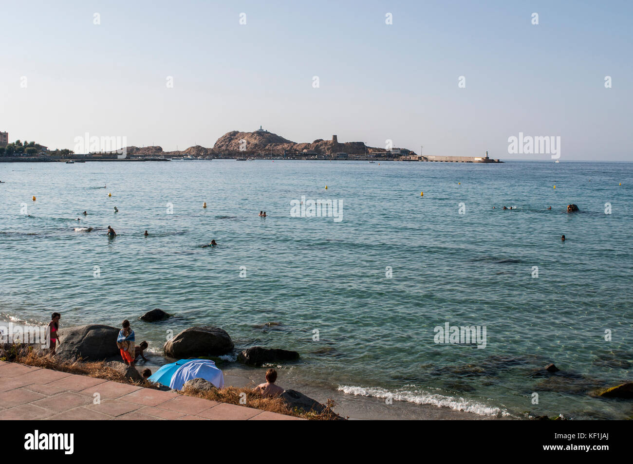 Corse : la plage de l'Île-rousse (l'île rouge) avec vue sur la tour génoise et pietra phare sur le haut de l'ile de la pietra (pierre) Banque D'Images