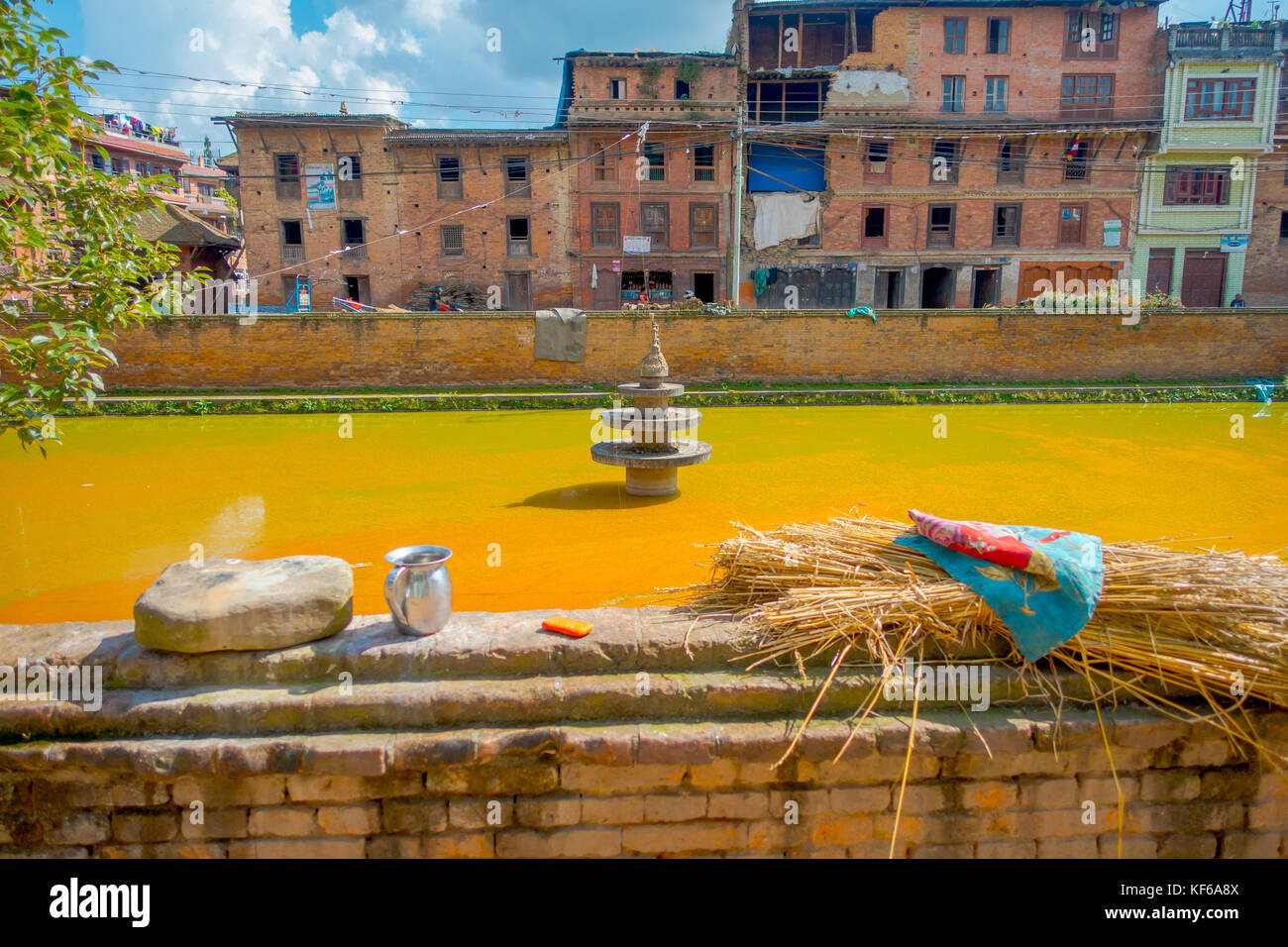 BHAKTAPUR, NÉPAL - 04 NOVEMBRE 2017 : gros plan de la scène urbaine traditionnelle avec un étang artificiel d'eau jaune dans la ville de Bhaktapur, Népal Banque D'Images