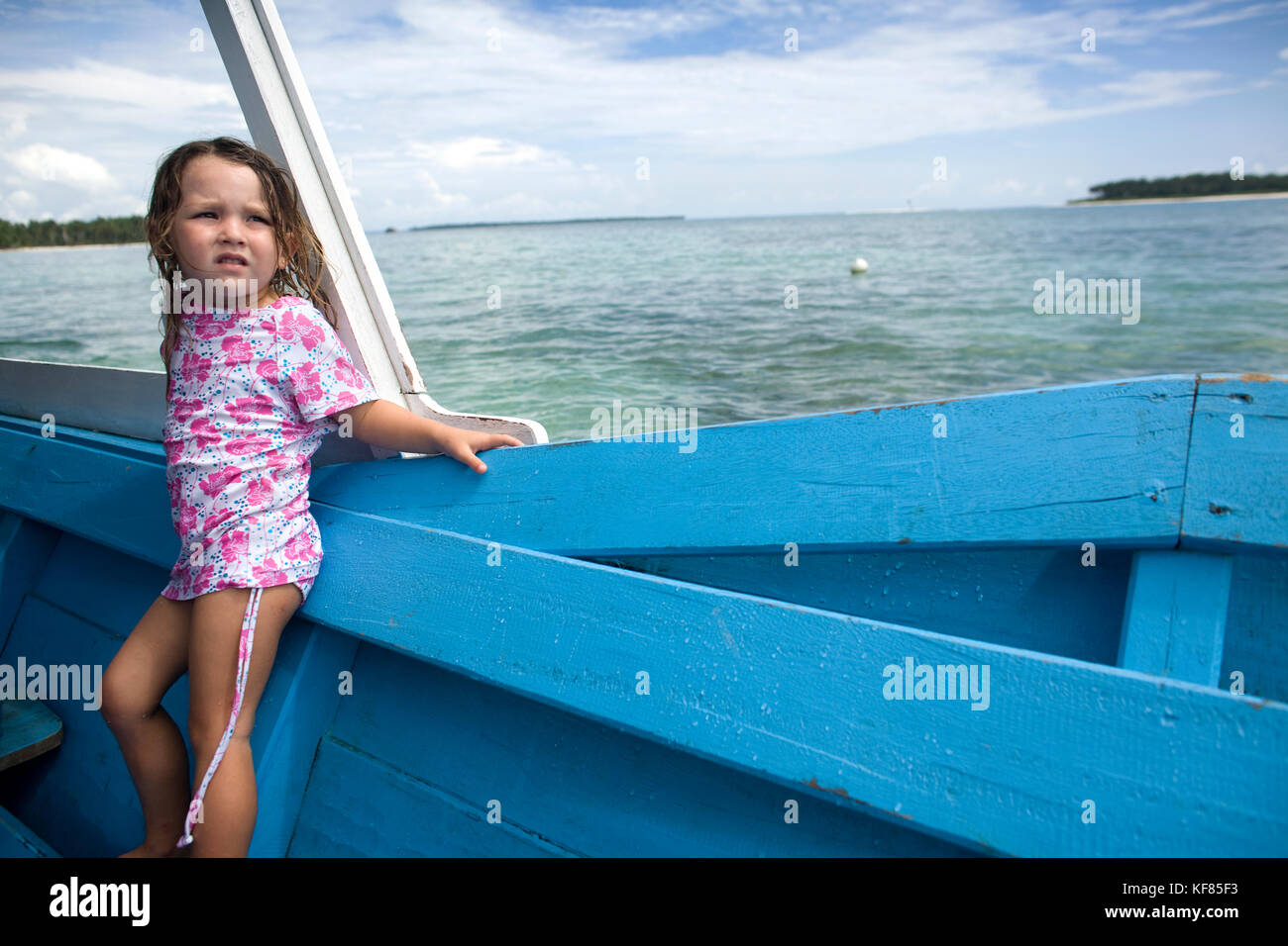 L'Indonésie, les îles Mentawai, kandui left Surf resort, fille debout dans un bateau en bois, à l'écart Banque D'Images