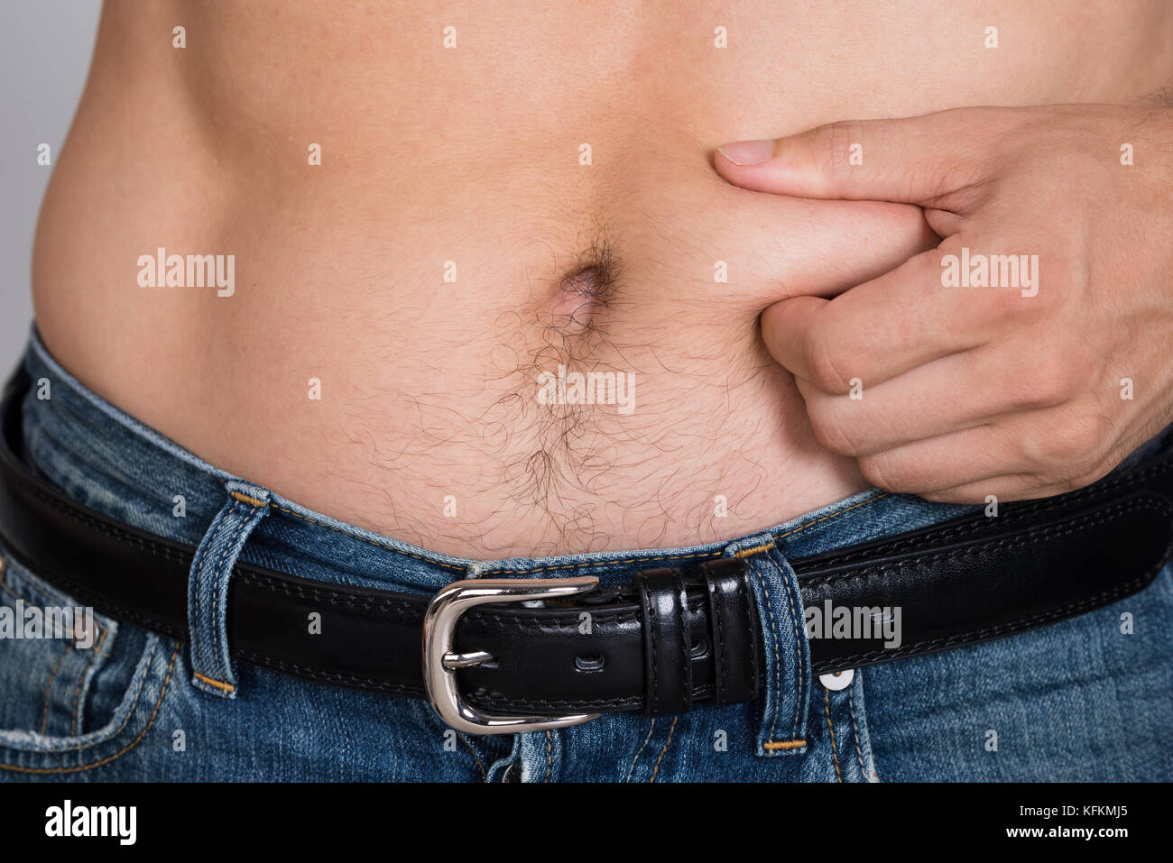 Closeup portrait of man holding belly fat Banque D'Images