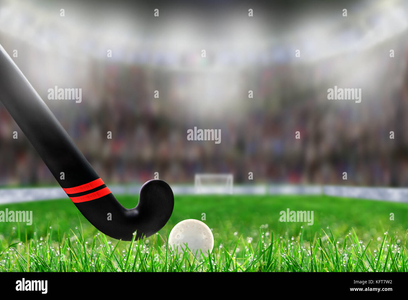 Low angle view of field hockey stick and ball sur terrain herbe et délibérée, faible profondeur de champ sur l'arrière-plan du stade bien éclairé avec copie espace. Banque D'Images