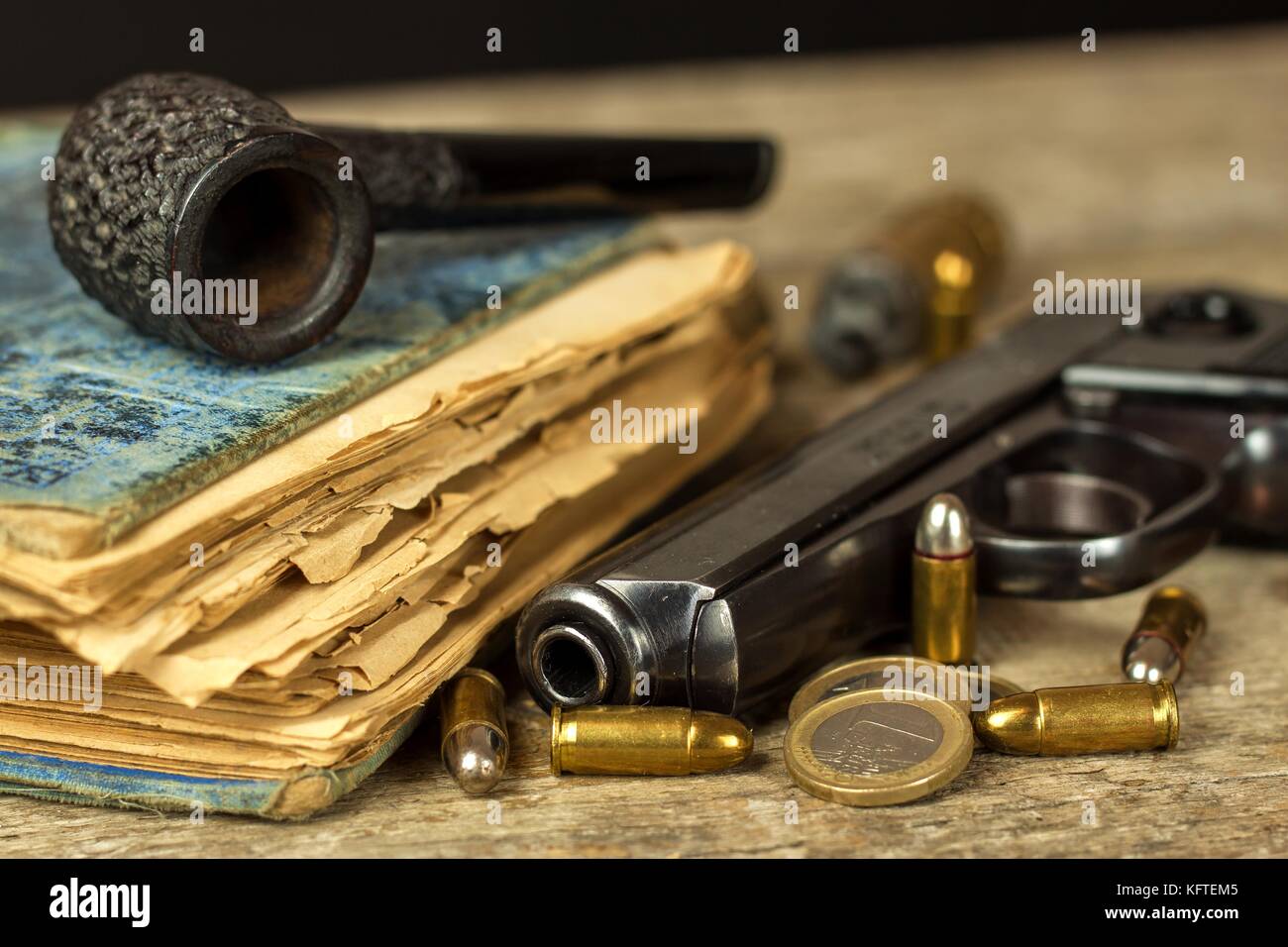 Arme et vieux livre. roman policier. pipe en bois. pistolets et cartouches sur la table Banque D'Images