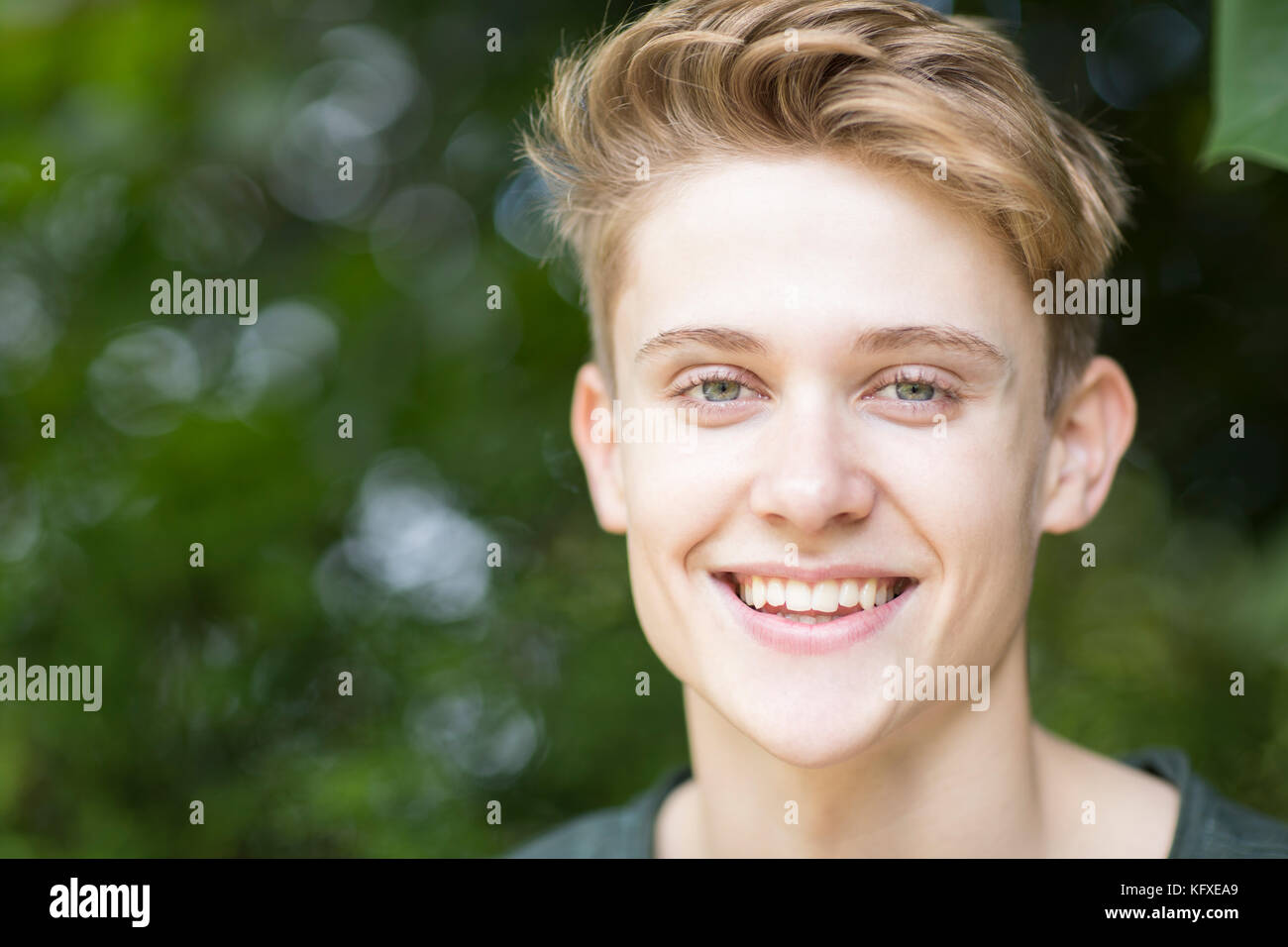 Portrait of happy Young boy sitting outdoors Banque D'Images