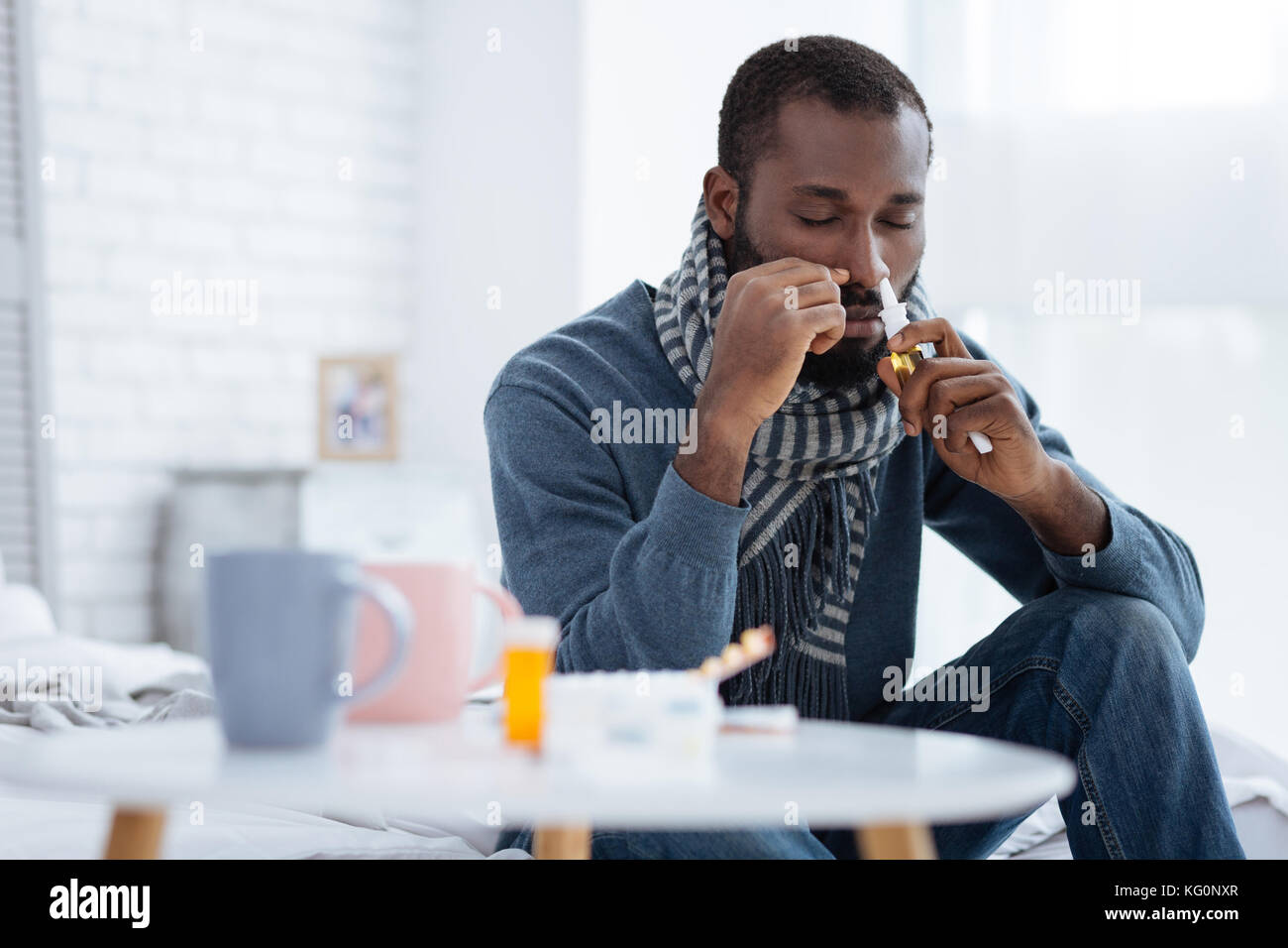 L'homme malade de fermer les yeux pendant l'utilisation de gouttes spéciales Banque D'Images