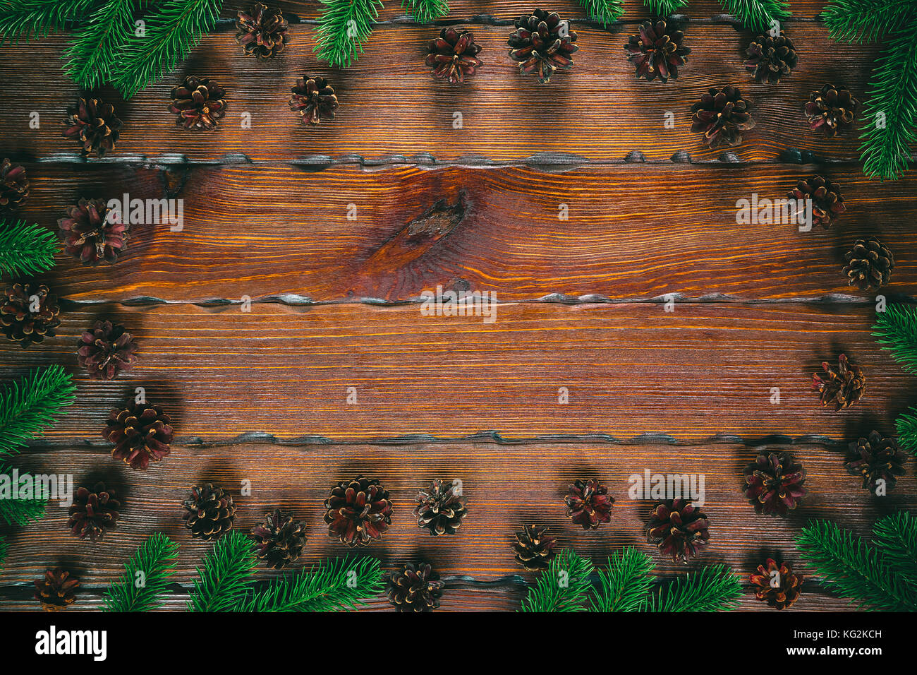 Cadre de Noël avec des pommes de pin, branches de sapin sur fond marron en bois composition de noël.. Vue de dessus, l'espace libre Banque D'Images Cadre de Noël avec des pommes de pin, branches de sapin sur fond marron en bois composition de noël.. Vue de dessus, l'espace libre Banque D'Images