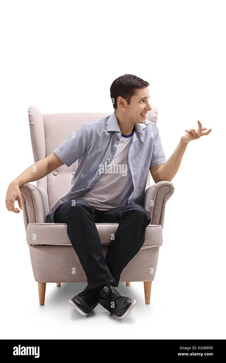 Jeune homme assis dans un fauteuil et parler isolé sur fond blanc Photo  Stock - Alamy
