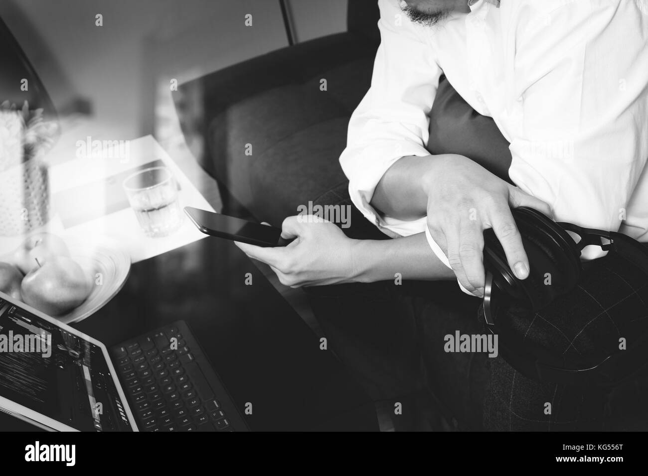Hipster hand holding digital tablet,casque clavier d' et les entreprises en ligne, les paiements mobiles omni channel,sitting on sofa in living room,g Banque D'Images