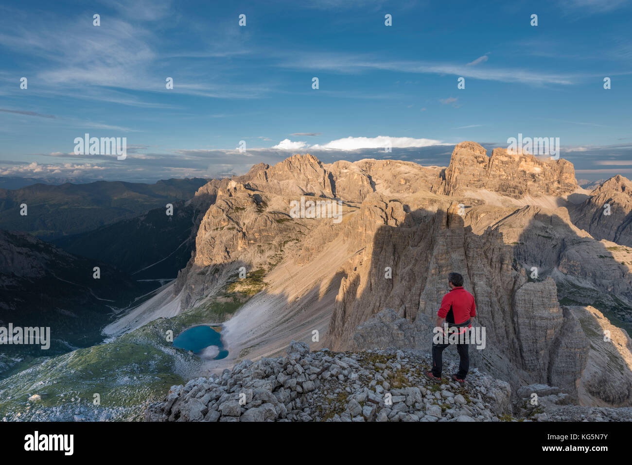 Sesto / Sexten, province de Bolzano, Dolomites, Tyrol du Sud, Italie. Un alpiniste admire l'alpenglow au sommet du mont Paterno Banque D'Images