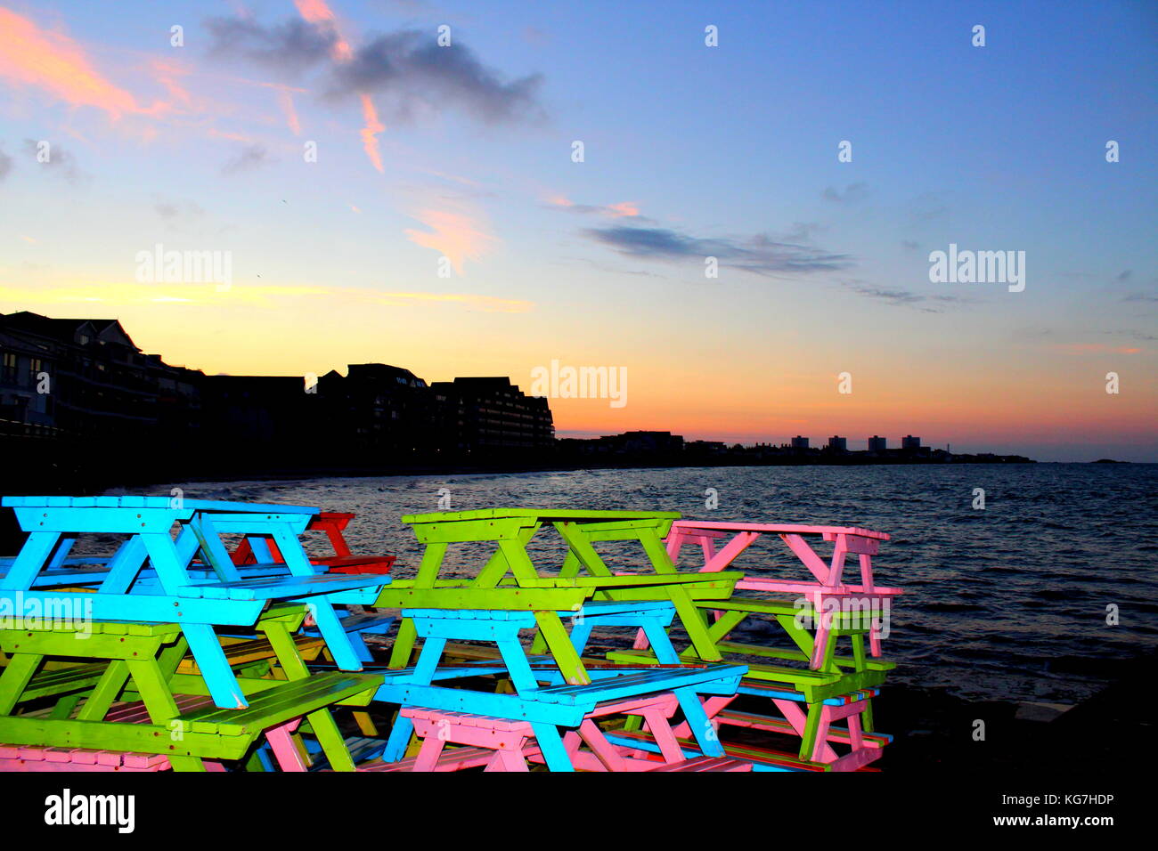 Des bancs de couleur vive à l'aube sur Havre des Pas Banque D'Images