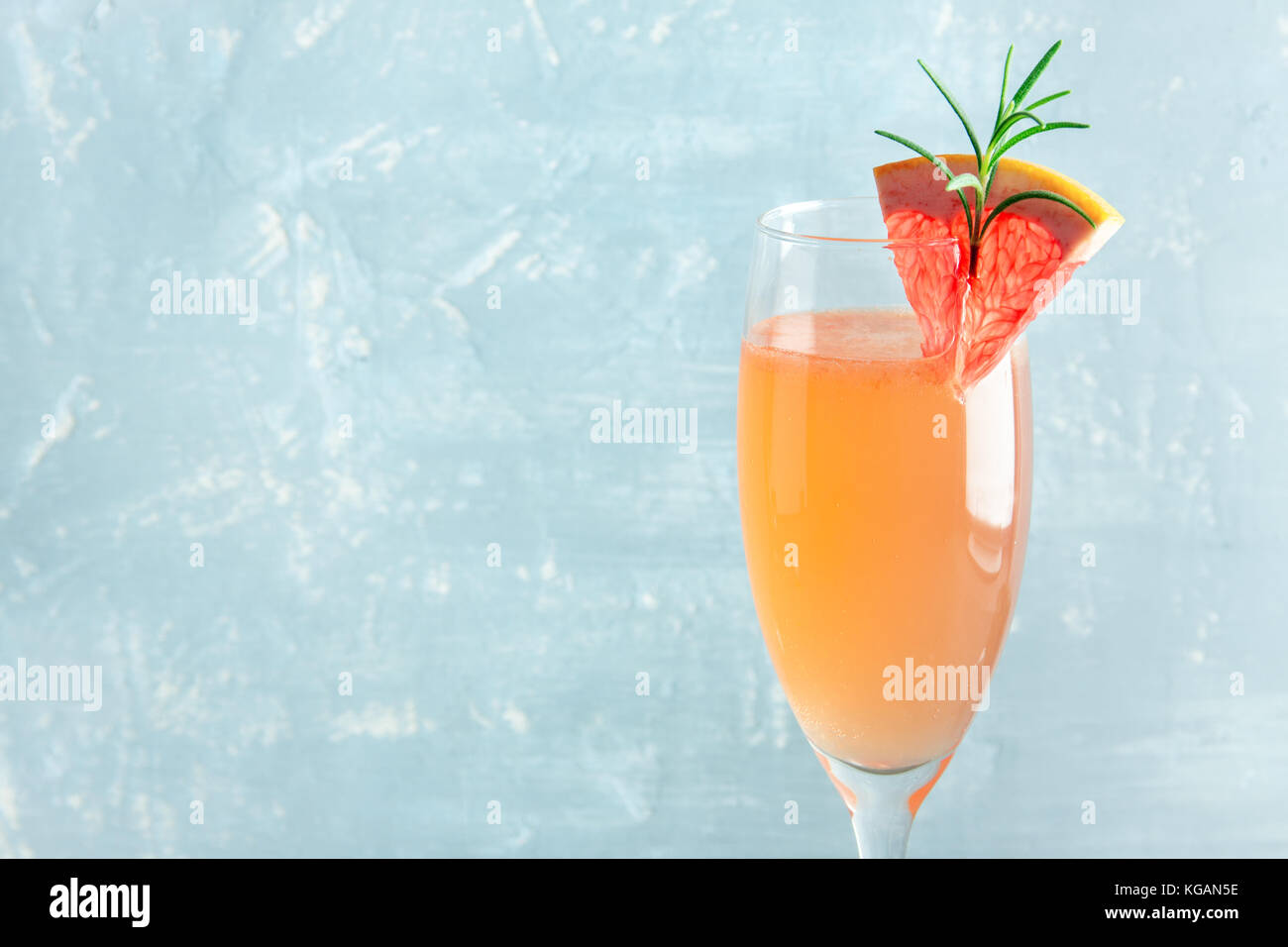 Boisson festive mimosa - cocktail au champagne mimosa avec du pamplemousse et romarin pour une fête de Noël, copy space Banque D'Images