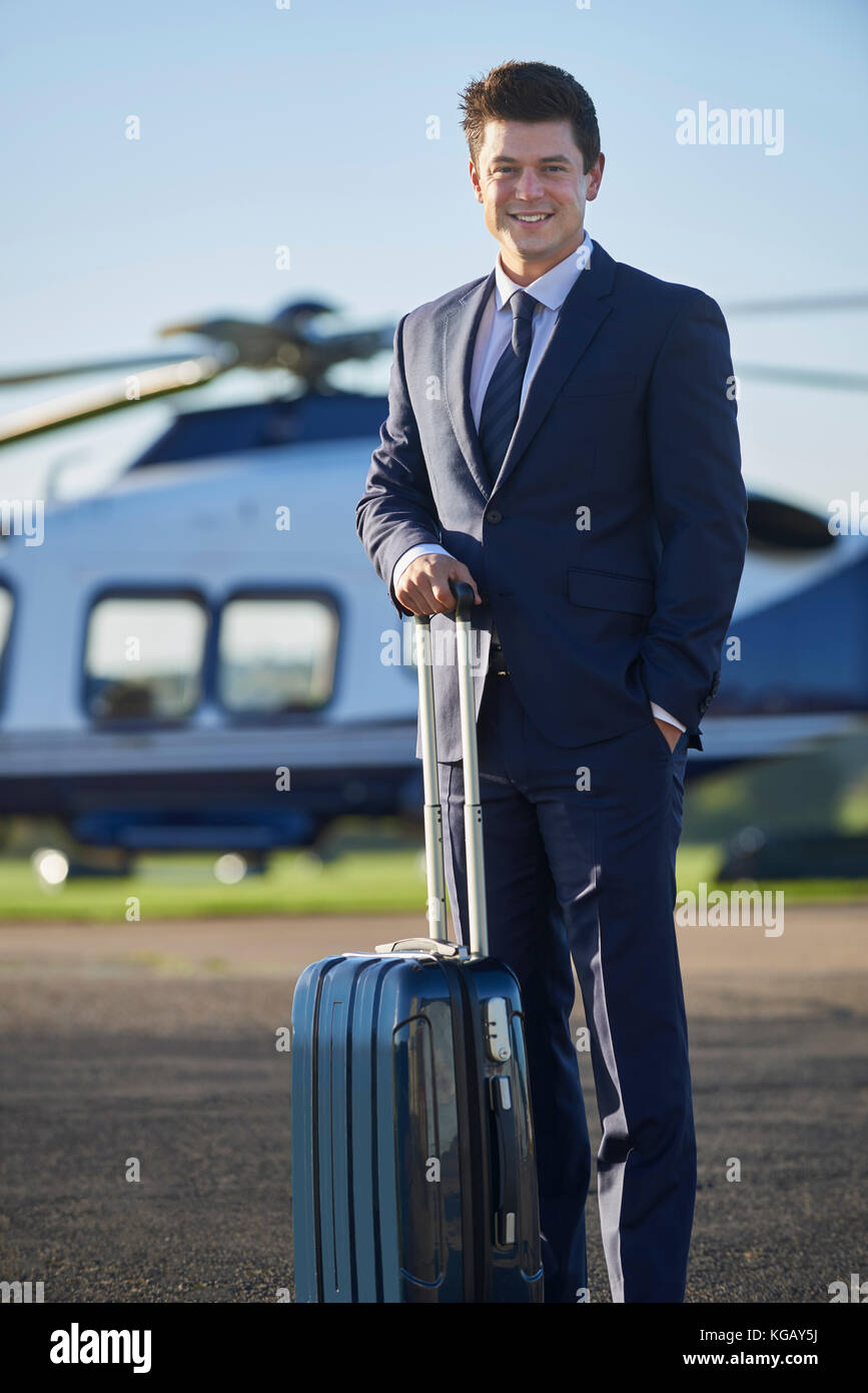 Portrait of businessman standing in front of helicopter Banque D'Images