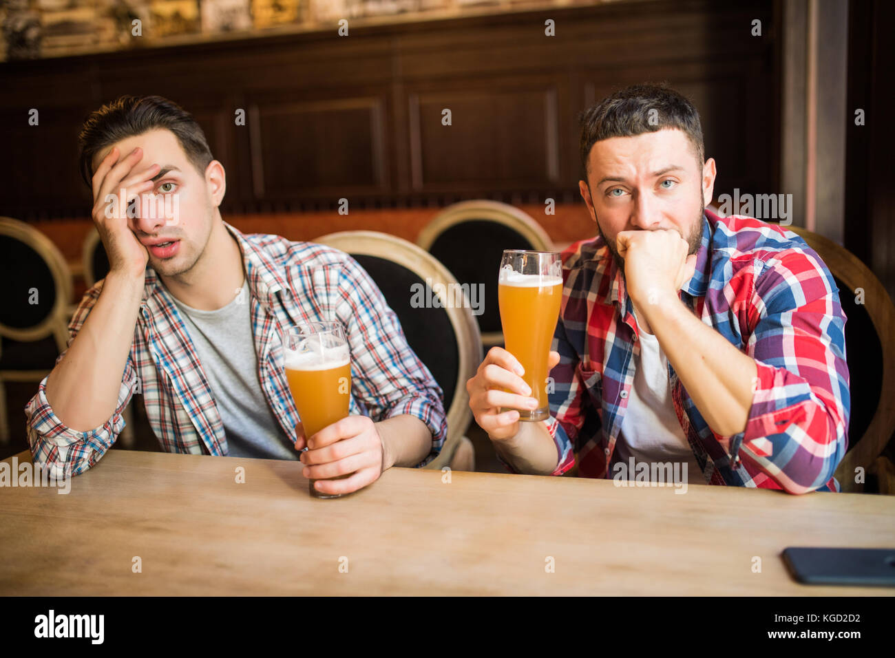 Jeune homme barbu qui semble contrariée et triste d'avoir de la bière au pub copyspace dépression fatigue stress Banque D'Images