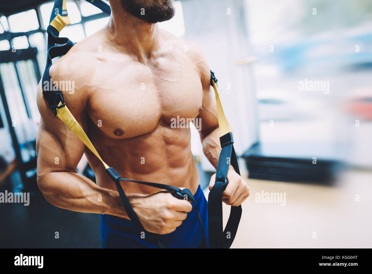 Young handsome man doing exercises in gym Banque D'Images