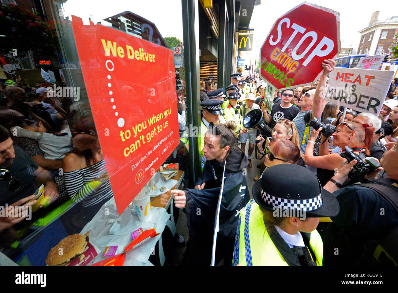 Les activistes végétaliens assiégeant un restaurant McDonalds dans Whitehall Londres pendant une manifestation de protestation pour les droits des animaux mars rallye. Cordon de police en place Banque D'Images