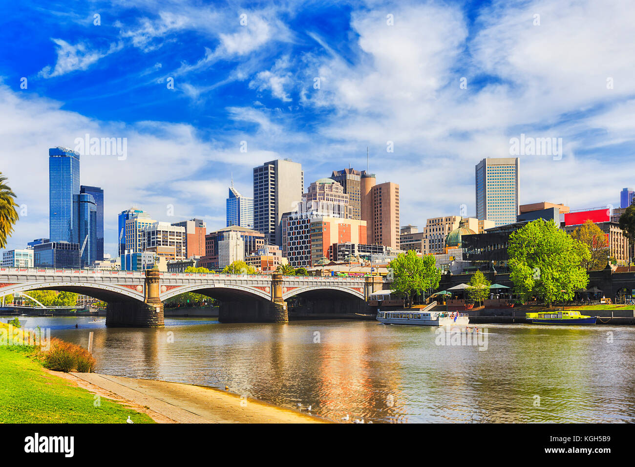 Princes bridge à Melbourne City à travers la rivière Yarra sur une journée ensoleillée en vue de hautes tours et de l'architecture urbaine moderne. Banque D'Images