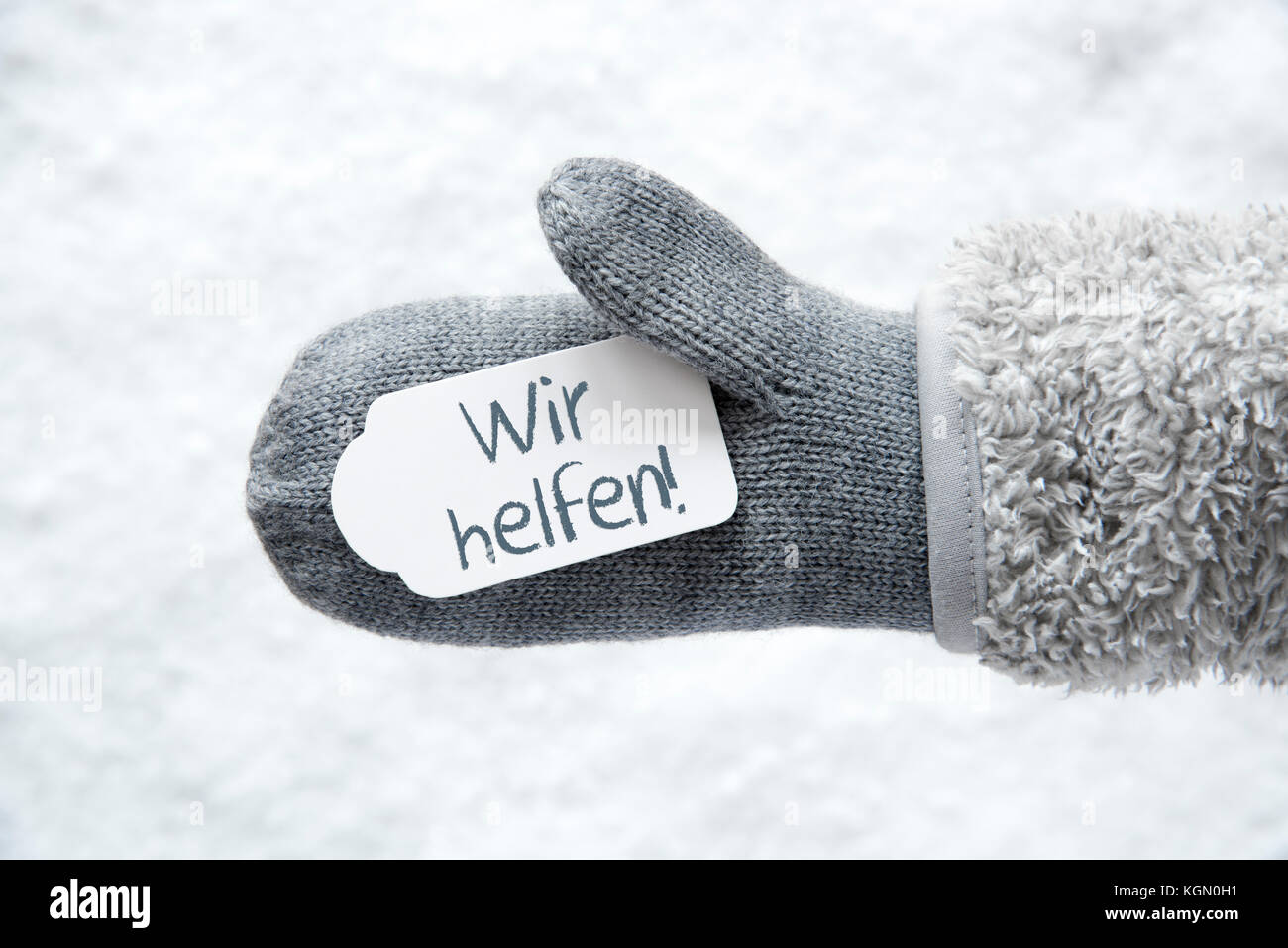 Gant en laine, label, neige, Wir helfen signifie nous aider Banque D'Images