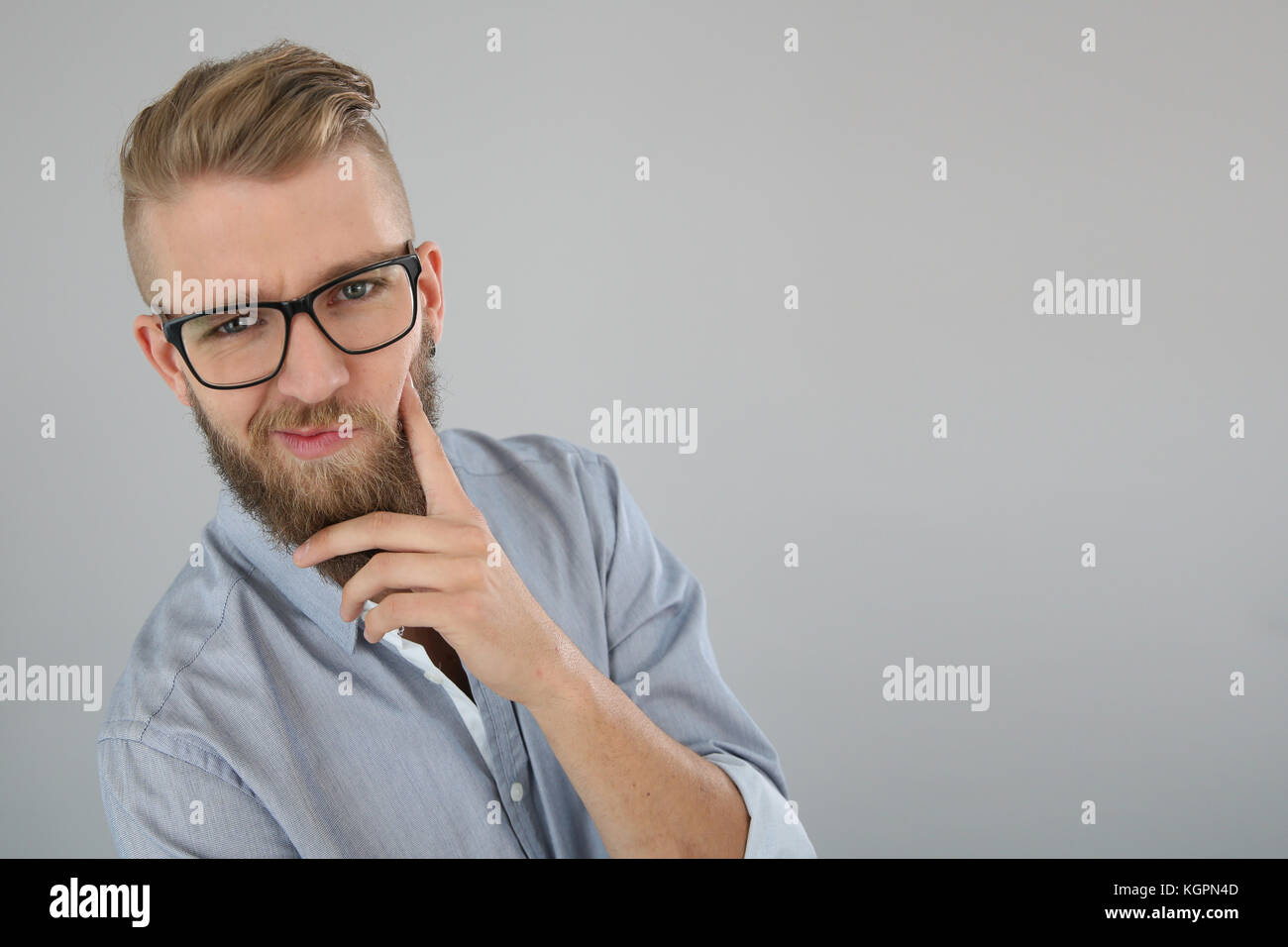 Jeune homme à la barbe d'avoir un look douteux Photo Stock - Alamy