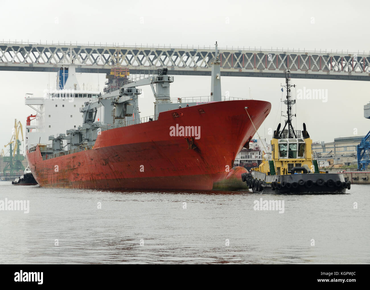 Remorqueur tirant un grand pétrolier du port après qu'il est téléchargé. Banque D'Images